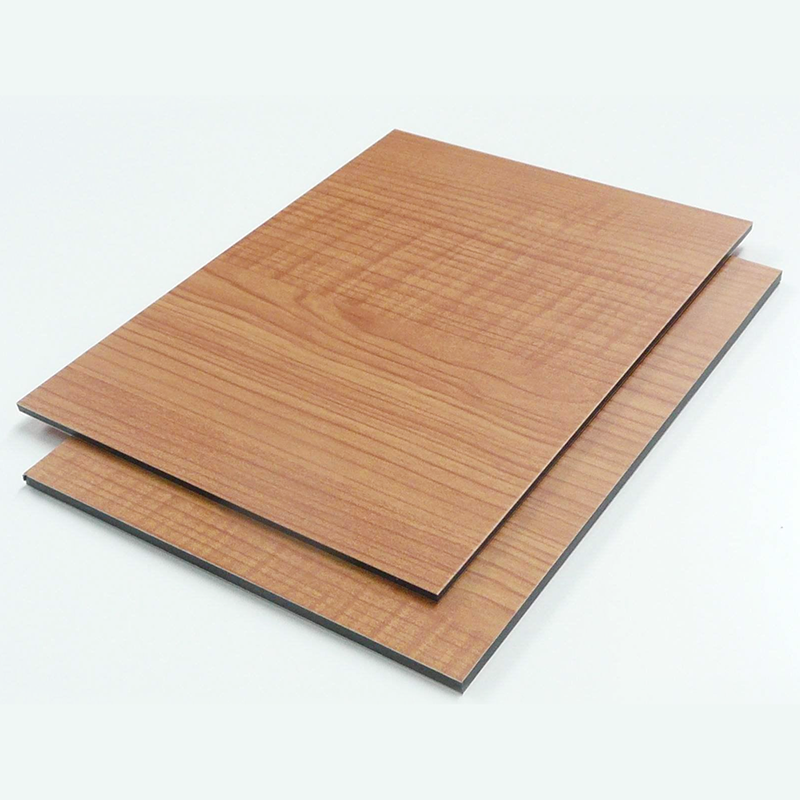 What is the process of spraying wood grain aluminum veneer many times?